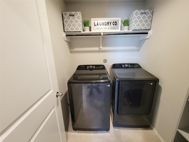 4931 Marina Shores Ct, Katy, TX 77493 - laundry area with washing machine and clothes dryer, light tile patterned flooring, and baseboards