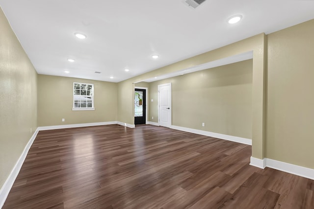 basement featuring dark wood finished floors, baseboards, and recessed lighting