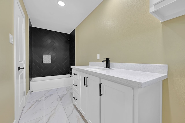 bathroom with marble finish flooring, vanity, and recessed lighting