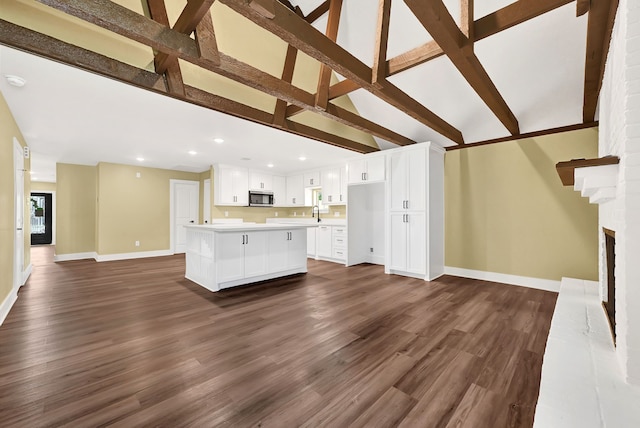unfurnished living room with baseboards, dark wood-style flooring, recessed lighting, and a fireplace