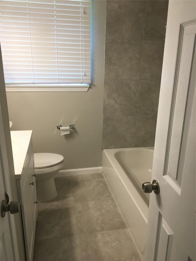 full bathroom with vanity, toilet, baseboards, and tile patterned flooring
