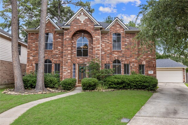 20106 Pinehaven Ln, Spring, TX 77379 - traditional home featuring brick siding, a front yard, concrete driveway, and a shingled roof