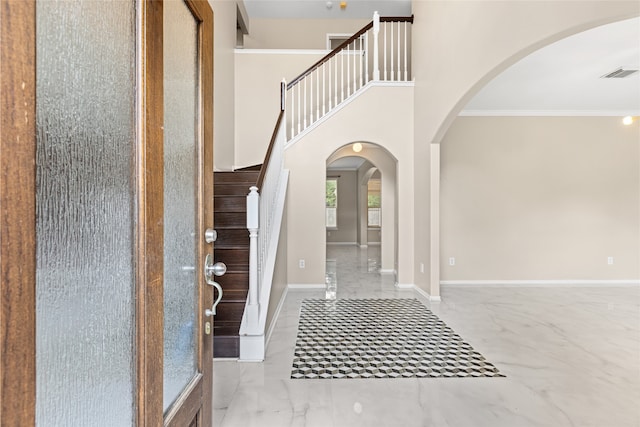 20106 Pinehaven Ln, Spring, TX 77379 - entryway with arched walkways, marble finish flooring, stairs, crown molding, and baseboards