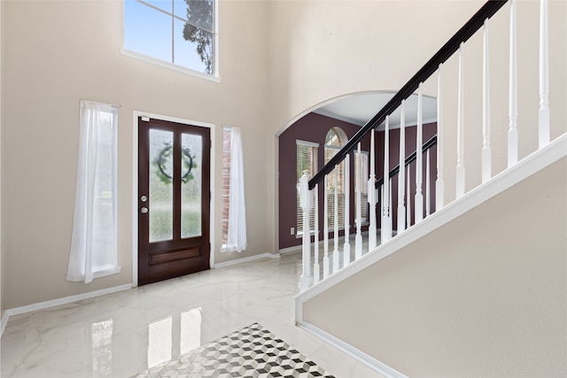 20106 Pinehaven Ln, Spring, TX 77379 - foyer entrance with arched walkways, marble tiled flooring, a towering ceiling, stairway, and baseboards