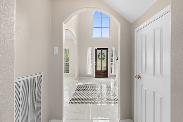 20106 Pinehaven Ln, Spring, TX 77379 - foyer featuring marble finish floors, vaulted ceiling, arched walkways, and baseboards