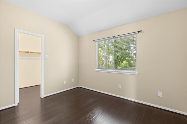 20106 Pinehaven Ln, Spring, TX 77379 - unfurnished bedroom with a walk in closet, lofted ceiling, dark wood-style flooring, baseboards, and a closet