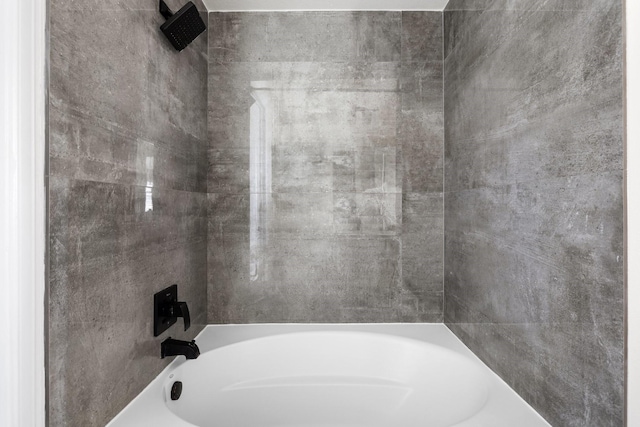 bathroom featuring a tub and a shower