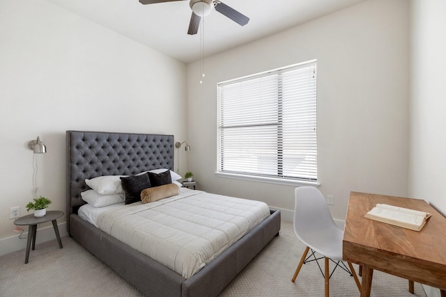 bedroom with carpet floors, an office area, ceiling fan, and baseboards