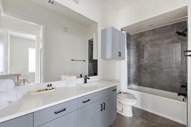 full bath featuring toilet, tub / shower combination, vanity, and tile patterned floors