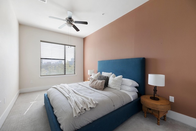 carpeted bedroom featuring baseboards and ceiling fan