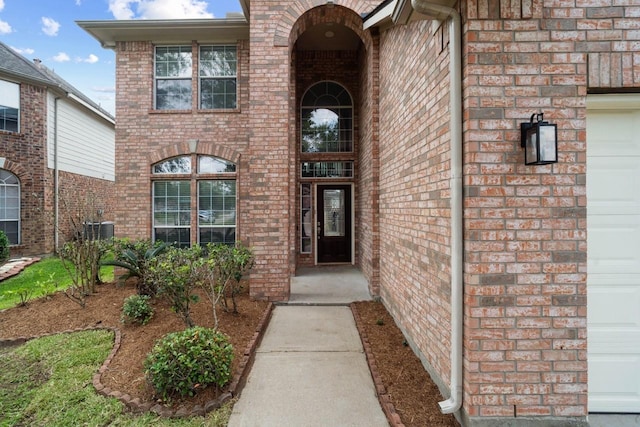 12506 Emerald Springs Dr, Pearland, TX 77584 - view of exterior entry with brick siding and central air condition unit
