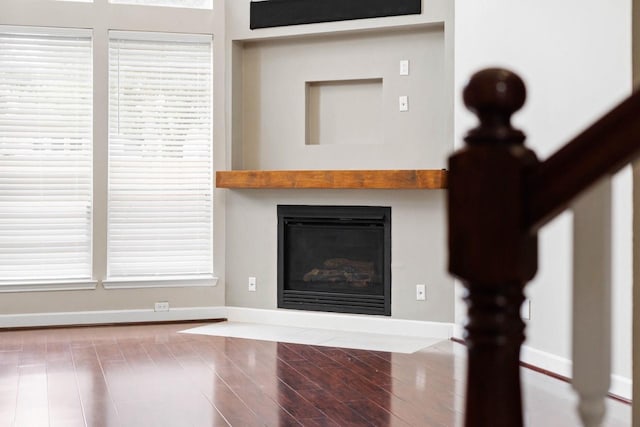 12506 Emerald Springs Dr, Pearland, TX 77584 - detailed view of a glass covered fireplace, baseboards, and wood finished floors
