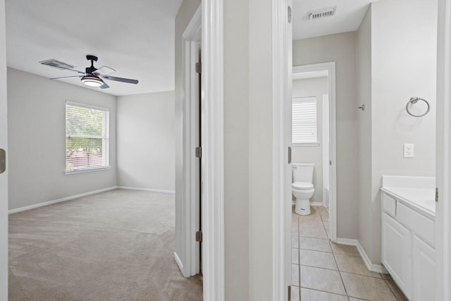 12506 Emerald Springs Dr, Pearland, TX 77584 - bathroom with a ceiling fan, toilet, vanity, baseboards, and tile patterned flooring