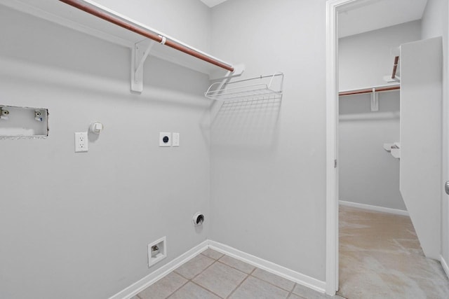 12506 Emerald Springs Dr, Pearland, TX 77584 - laundry room featuring gas dryer hookup, hookup for an electric dryer, washer hookup, baseboards, and light tile patterned floors
