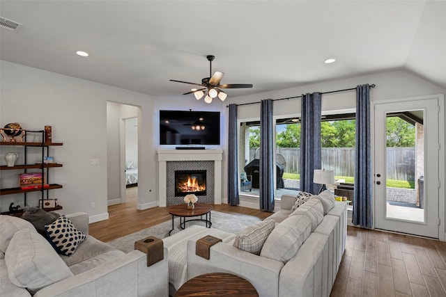 19322 Stagecoach Breeze Ln, Tomball, TX 77377 - living room featuring wood finished floors, healthy amount of natural light, a ceiling fan, vaulted ceiling, and a fireplace