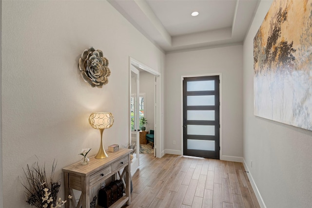 19322 Stagecoach Breeze Ln, Tomball, TX 77377 - foyer featuring light wood-type flooring, baseboards, a raised ceiling, and recessed lighting
