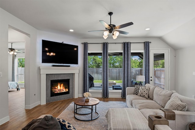 19322 Stagecoach Breeze Ln, Tomball, TX 77377 - living room featuring ceiling fan, wood finished floors, a tile fireplace, recessed lighting, and vaulted ceiling