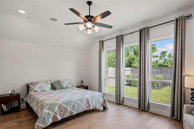 19322 Stagecoach Breeze Ln, Tomball, TX 77377 - bedroom featuring wood finished floors, vaulted ceiling, multiple windows, ceiling fan, and recessed lighting
