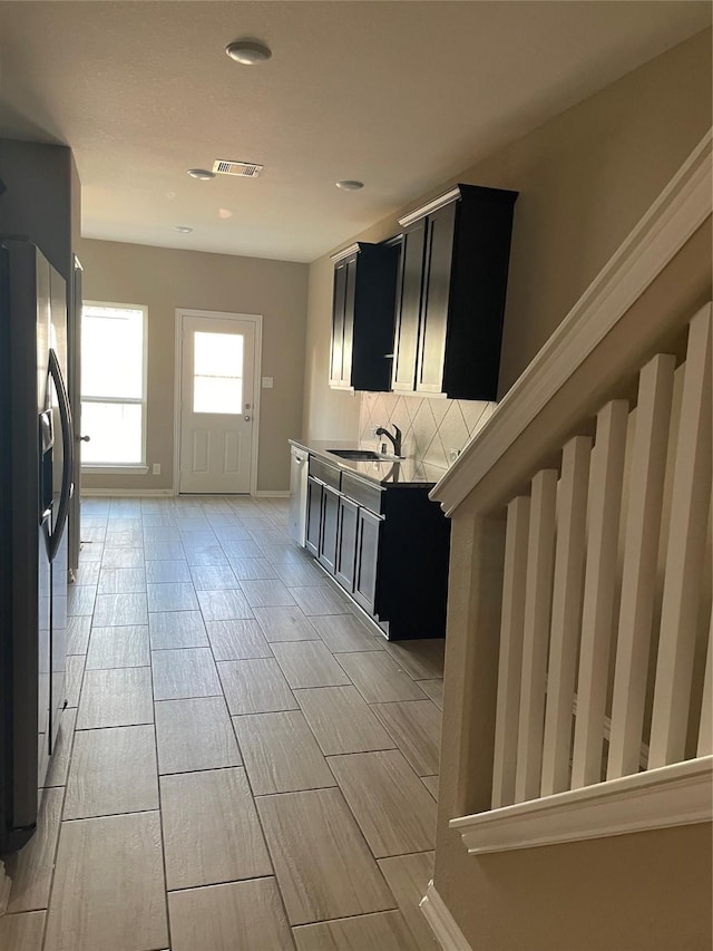 3230 Harmony Creek Ln, Spring, TX 77386 - kitchen with refrigerator with ice dispenser, dark cabinets, a sink, tasteful backsplash, and recessed lighting