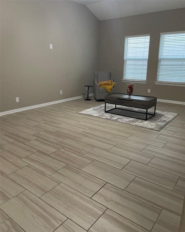 3230 Harmony Creek Ln, Spring, TX 77386 - living area featuring lofted ceiling, baseboards, and light wood-type flooring