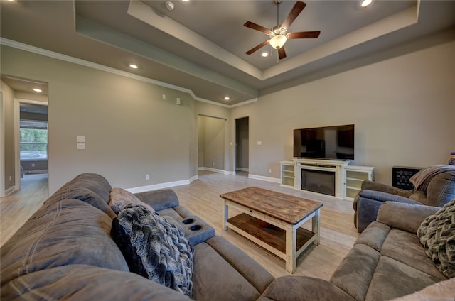 26495 Pin Oak Dr, Hempstead, TX 77445 - living area featuring a raised ceiling, a ceiling fan, baseboards, recessed lighting, and light wood-style floors