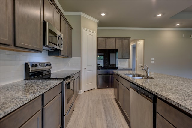 26495 Pin Oak Dr, Hempstead, TX 77445 - kitchen with appliances with stainless steel finishes, a sink, dark brown cabinets, crown molding, and light stone counters