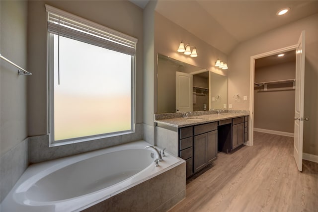 26495 Pin Oak Dr, Hempstead, TX 77445 - full bath featuring a walk in closet, a garden tub, wood finished floors, vanity, and recessed lighting