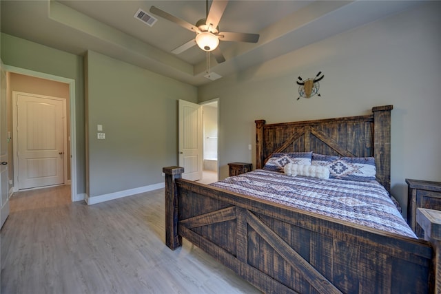 26495 Pin Oak Dr, Hempstead, TX 77445 - bedroom featuring a tray ceiling, wood finished floors, baseboards, and a ceiling fan