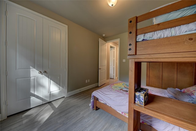 26495 Pin Oak Dr, Hempstead, TX 77445 - bedroom with wood finished floors, baseboards, and a closet