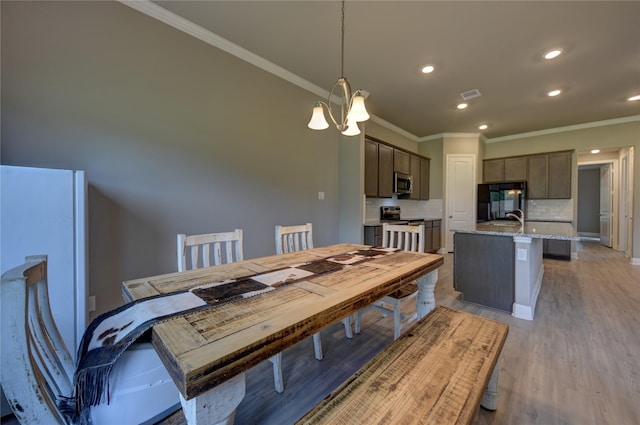 26495 Pin Oak Dr, Hempstead, TX 77445 - dining space featuring ornamental molding, light wood-type flooring, and recessed lighting
