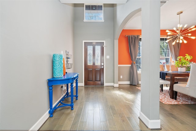 2505 Cypress Springs Ct, Pearland, TX 77584 - foyer featuring a chandelier, hardwood / wood-style flooring, arched walkways, and baseboards