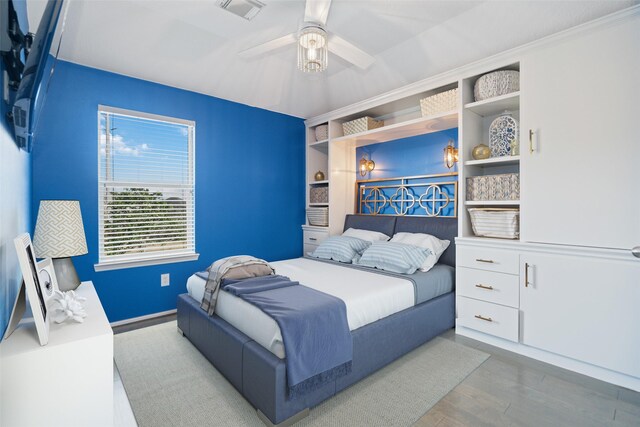 2505 Cypress Springs Ct, Pearland, TX 77584 - bedroom featuring wood finished floors, a ceiling fan, baseboards, and ornamental molding