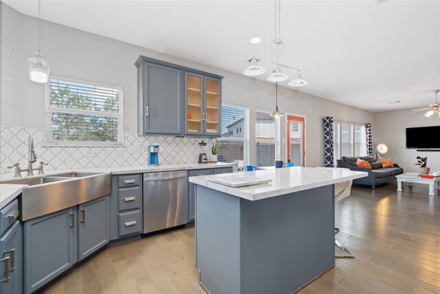 2505 Cypress Springs Ct, Pearland, TX 77584 - kitchen featuring stainless steel dishwasher, a sink, healthy amount of natural light, and open floor plan