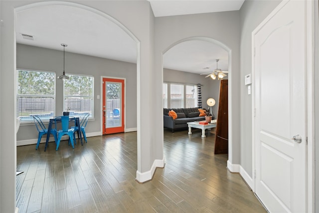 2505 Cypress Springs Ct, Pearland, TX 77584 - foyer entrance with arched walkways, baseboards, a ceiling fan, and dark wood-type flooring