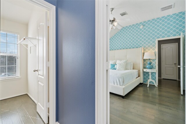 2505 Cypress Springs Ct, Pearland, TX 77584 - bedroom featuring wallpapered walls, lofted ceiling, wood finished floors, and baseboards