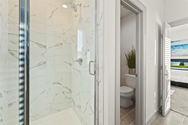 64 Dipping Ln, Houston, TX 77076 - bathroom with a marble finish shower, toilet, and healthy amount of natural light