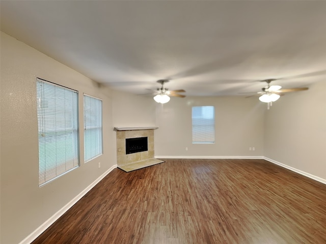 18481 Sunrise Oaks Ct, Montgomery, TX 77316 - unfurnished living room with a ceiling fan, healthy amount of natural light, dark wood-style flooring, and baseboards
