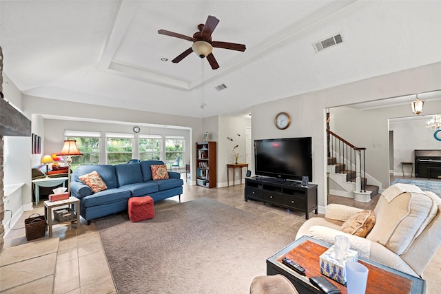 16107 York Minster Dr, Spring, TX 77379 - living room featuring stairs, light tile patterned floors, ceiling fan, a raised ceiling, and a chandelier