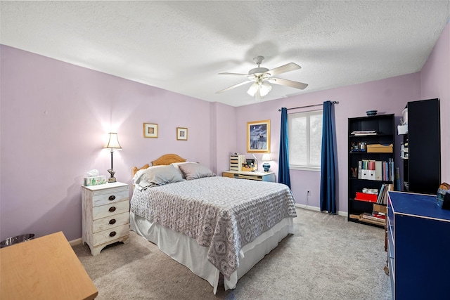 16107 York Minster Dr, Spring, TX 77379 - bedroom featuring light colored carpet, a textured ceiling, baseboards, and ceiling fan