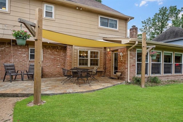 16107 York Minster Dr, Spring, TX 77379 - back of property featuring brick siding, a patio, a yard, a chimney, and roof with shingles