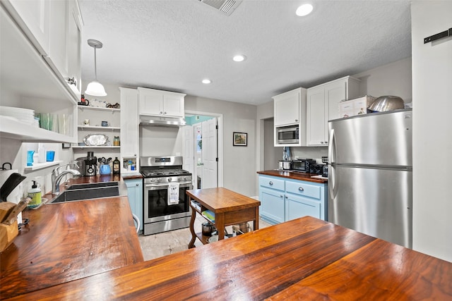 16107 York Minster Dr, Spring, TX 77379 - kitchen with butcher block countertops, appliances with stainless steel finishes, a sink, a textured ceiling, and recessed lighting