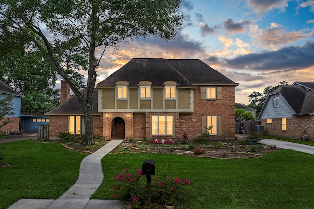 16107 York Minster Dr, Spring, TX 77379 - view of front of property featuring a front lawn, brick siding, cooling unit, and roof with shingles