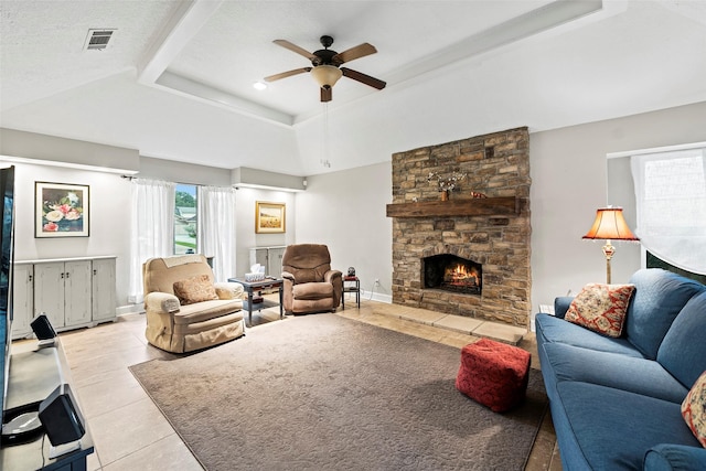 16107 York Minster Dr, Spring, TX 77379 - living room featuring ceiling fan, light tile patterned floors, a raised ceiling, and a fireplace