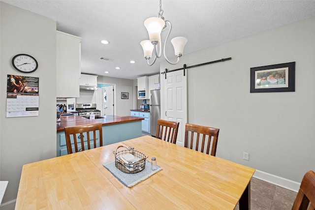 16107 York Minster Dr, Spring, TX 77379 - dining room featuring a barn door, baseboards, recessed lighting, and a chandelier