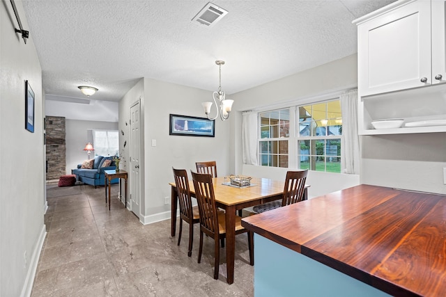 16107 York Minster Dr, Spring, TX 77379 - dining room with plenty of natural light, baseboards, a chandelier, and a textured ceiling