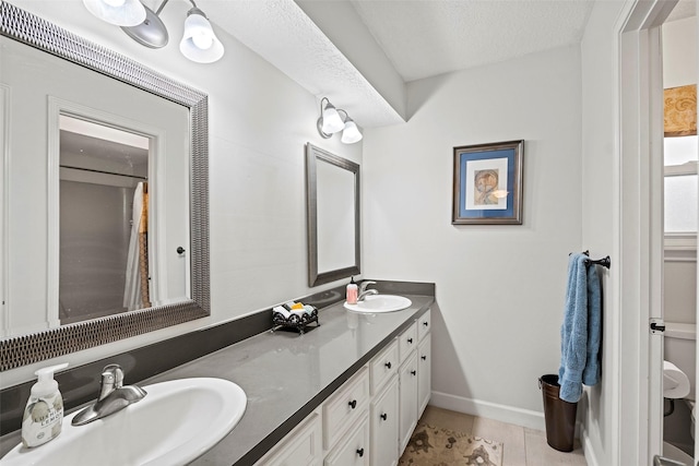 16107 York Minster Dr, Spring, TX 77379 - full bathroom with tile patterned floors, double vanity, and baseboards