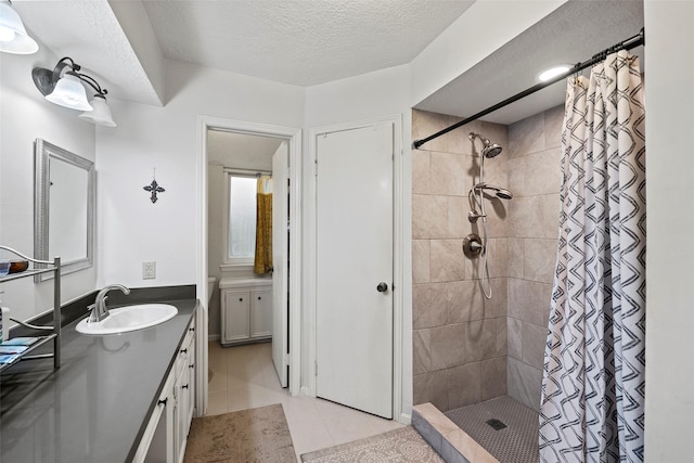 16107 York Minster Dr, Spring, TX 77379 - full bath with tiled shower, tile patterned flooring, vanity, and a textured ceiling