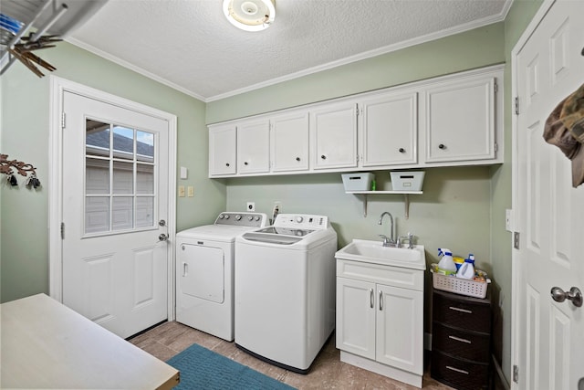 16107 York Minster Dr, Spring, TX 77379 - washroom with washing machine and clothes dryer, cabinet space, ornamental molding, and a textured ceiling