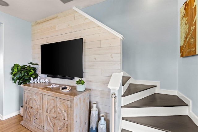 4114 Courageous Ln, Galveston, TX 77554 - staircase with wood finished floors, baseboards, and wood walls