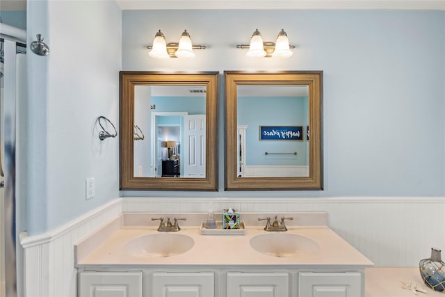 4114 Courageous Ln, Galveston, TX 77554 - bathroom with a wainscoted wall and double vanity